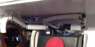 Misirlou’s gravity drain holding tank mid-installation showing tank valve, Tee to deck pump-out fitting and home-made activated charcoal vent filter. (Photo/ Tom Egan)